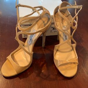 Jimmy Choo Lance heels in nude patent leather.